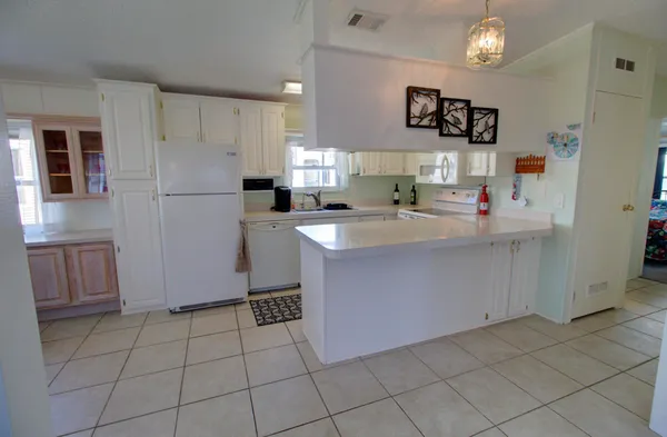 a kitchen with a sink a refrigerator and cabinets