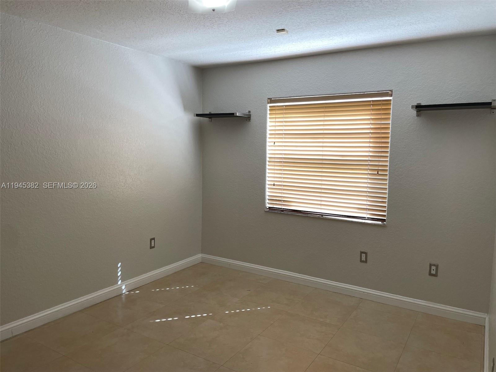 3559 West 74th Place Hialeah, FL 33018 - Photo 12 of 16 a view of an empty room with a window