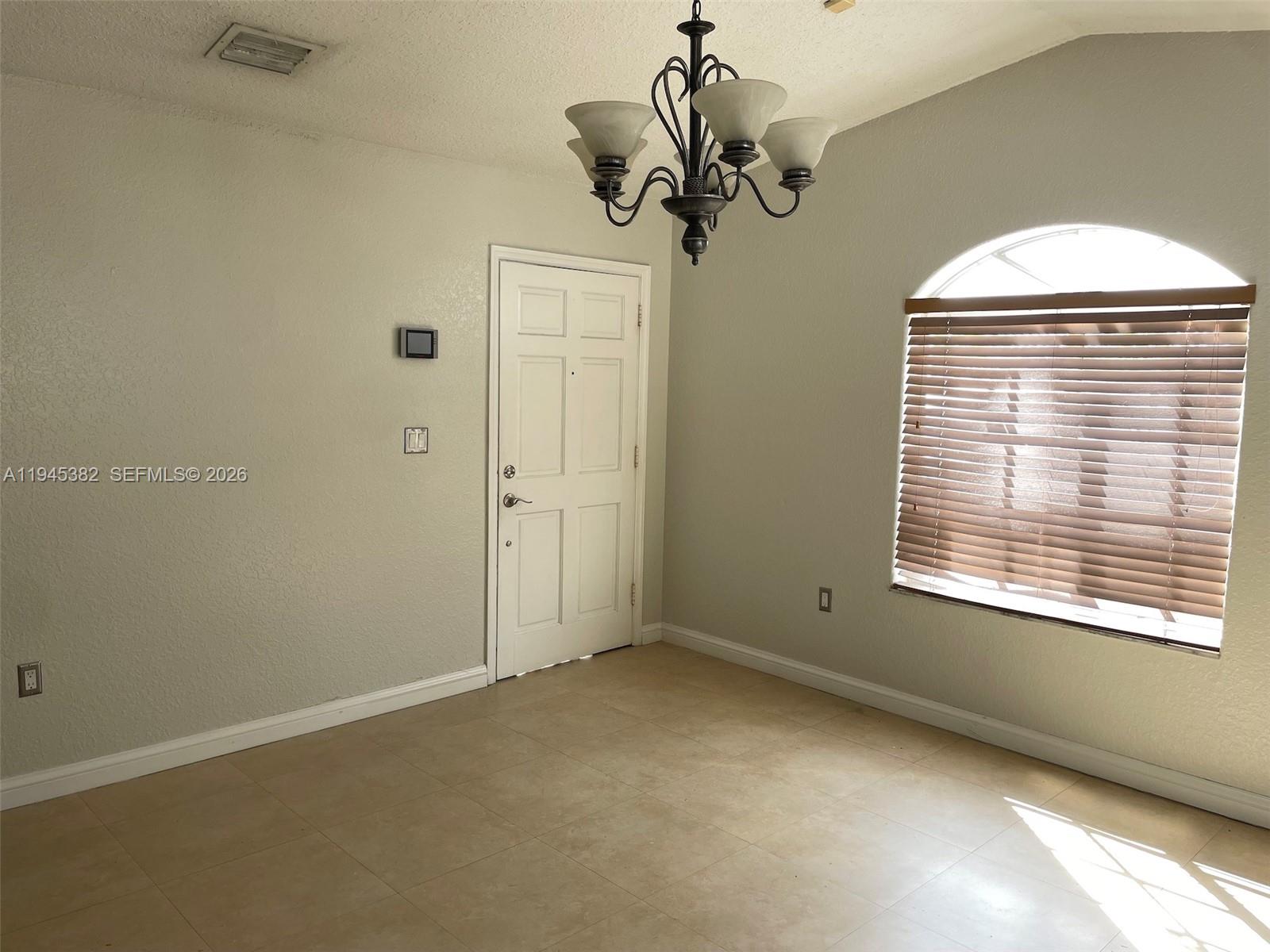 3559 West 74th Place Hialeah, FL 33018 - Photo 2 of 16 an empty room with a window