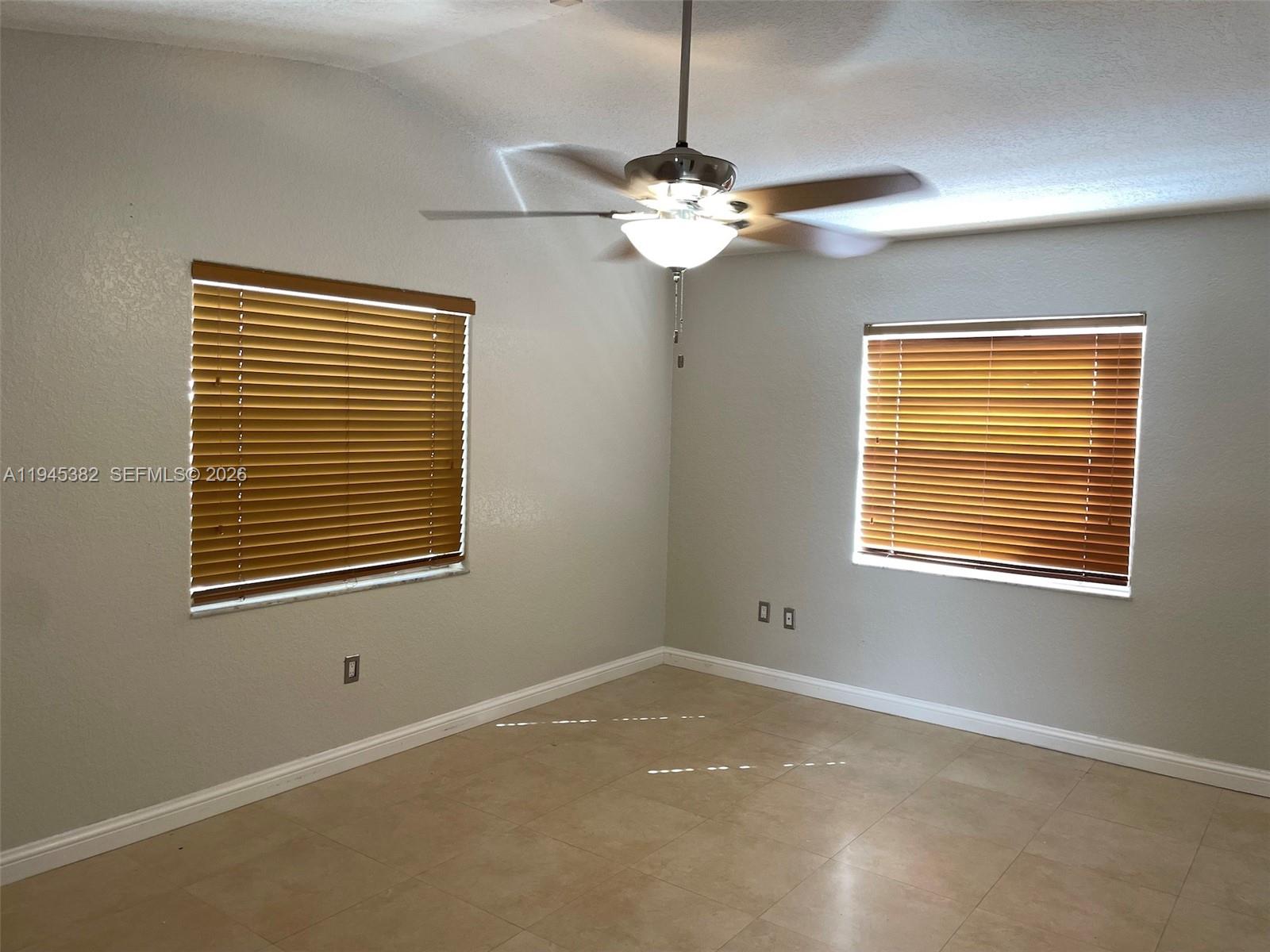 3559 West 74th Place Hialeah, FL 33018 - Photo 7 of 16 a view of an empty room with a window