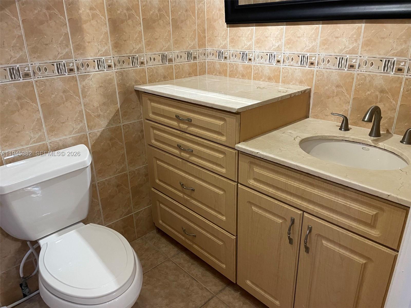 3559 West 74th Place Hialeah, FL 33018 - Photo 9 of 16 a bathroom with a sink a toilet and shower