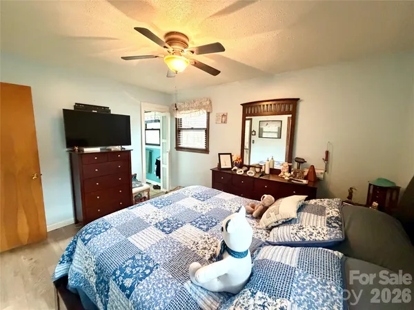 a bed room with a bed window and a television