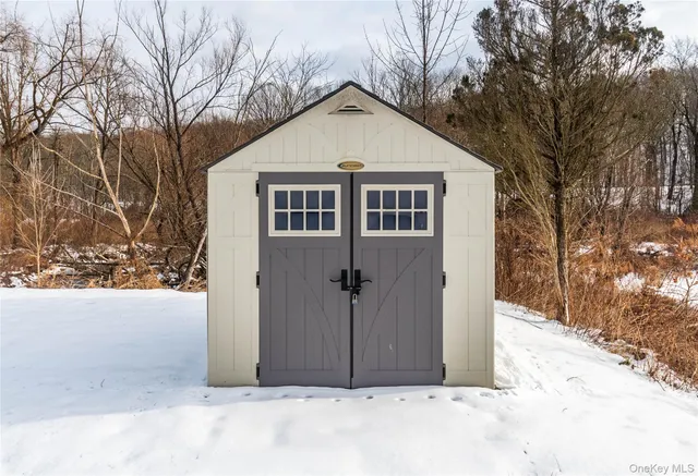 a view of a house with a yard covered in snow