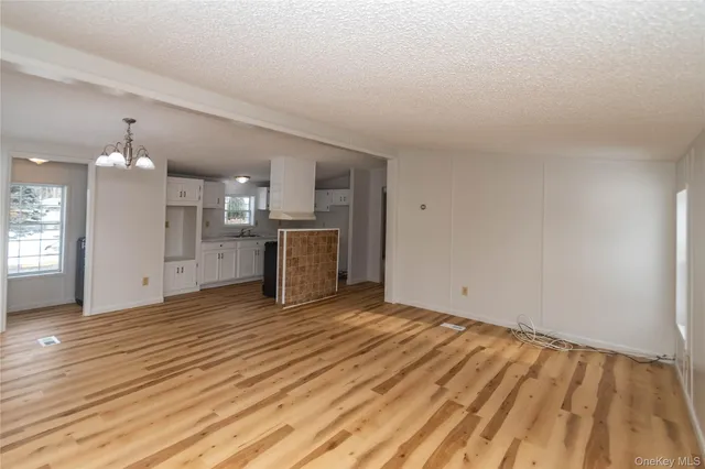 a view of a kitchen with a sink and a refrigerator