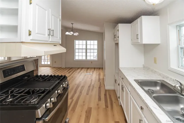 a kitchen that has a sink and a stove