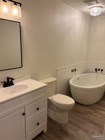 a white tub sitting next to a white sink