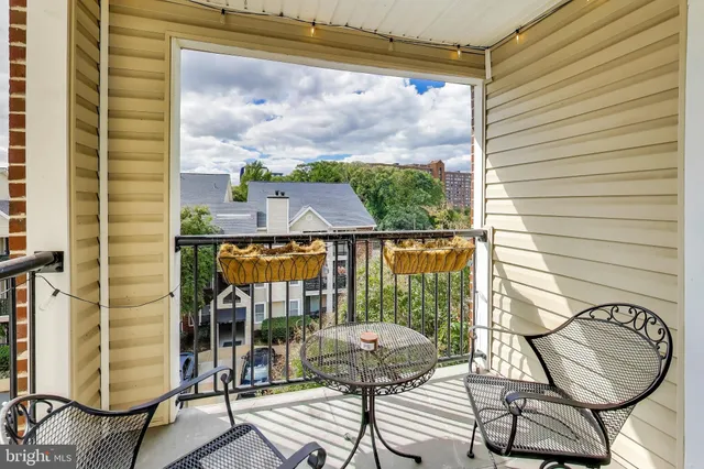 a balcony with table and chairs