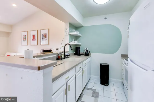 a kitchen with a sink cabinets and appliances