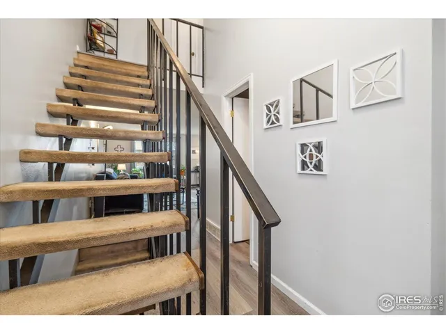 a bedroom with a bed a mirror and dresser