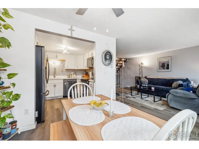 a kitchen with kitchen island granite countertop a sink stove and refrigerator