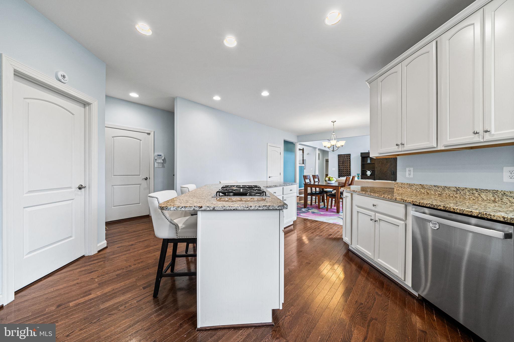1232 Shenandoah Road Alexandria, VA 22308 - Photo 24 of 50 a kitchen with stainless steel appliances granite countertop a table chairs stove a sink dishwasher and cabinets with wooden floor