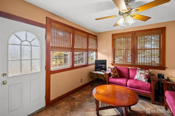 a living room with furniture a chandelier and a window