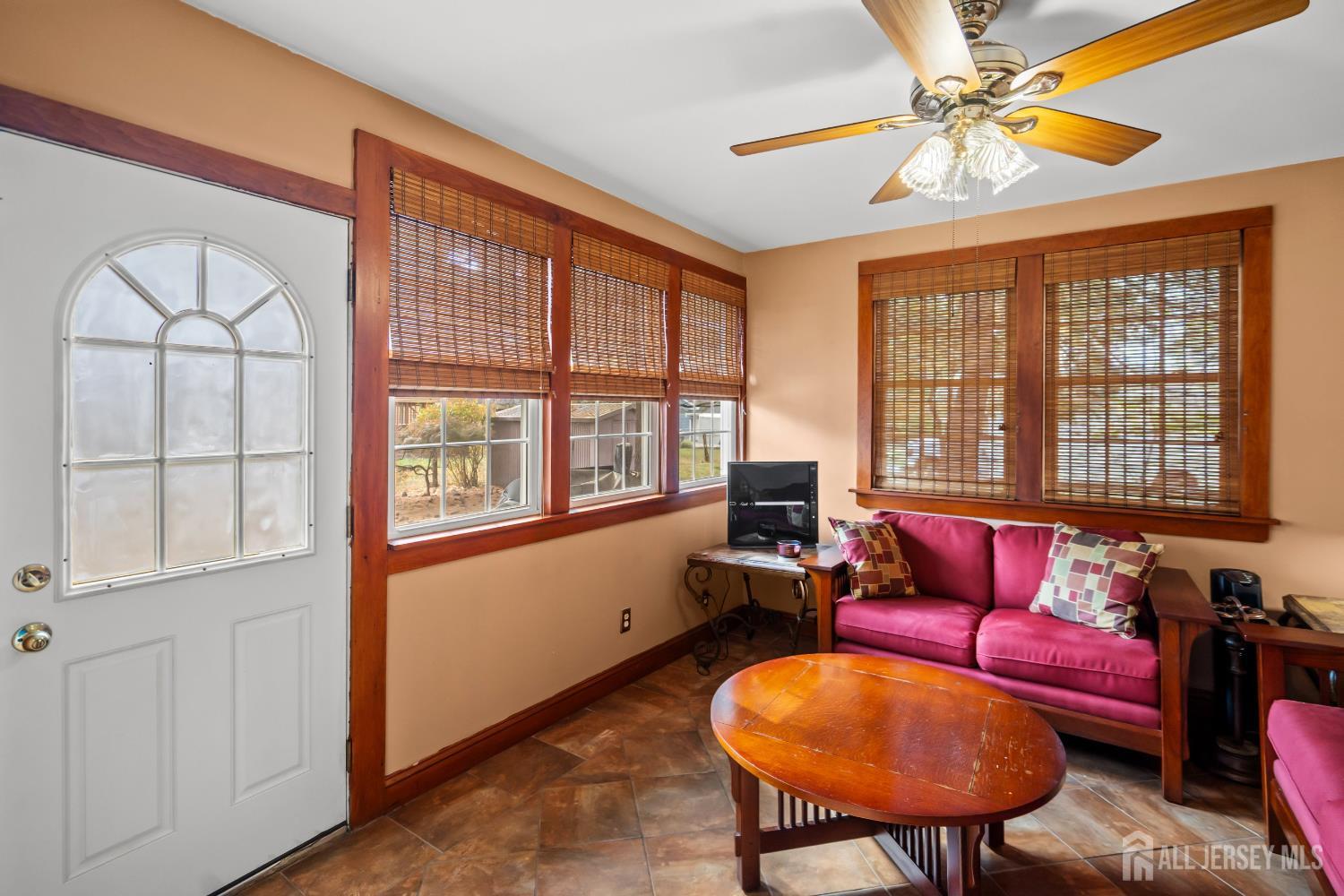 131 Woodland Road Piscataway, NJ 08854 - Photo 11 of 40 a living room with furniture a chandelier and a window