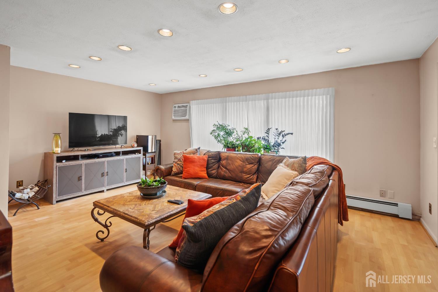 131 Woodland Road Piscataway, NJ 08854 - Photo 16 of 40 a living room with furniture and a flat screen tv