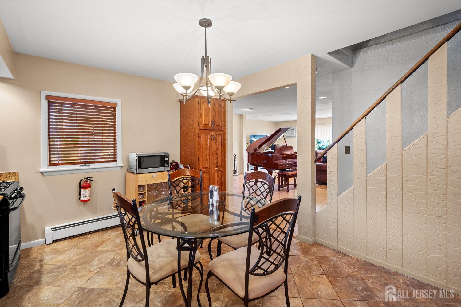 131 Woodland Road Piscataway, NJ 08854 - Photo 21 of 40 a view of a dining room and livingroom with furniture wooden floor a chandelier