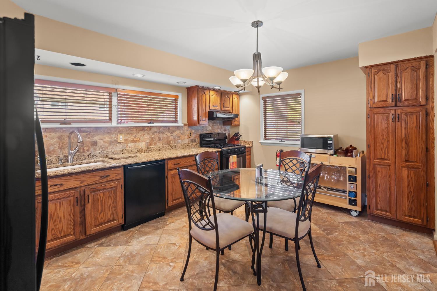 131 Woodland Road Piscataway, NJ 08854 - Photo 24 of 40 a view of a dining room with furniture window and wooden floor