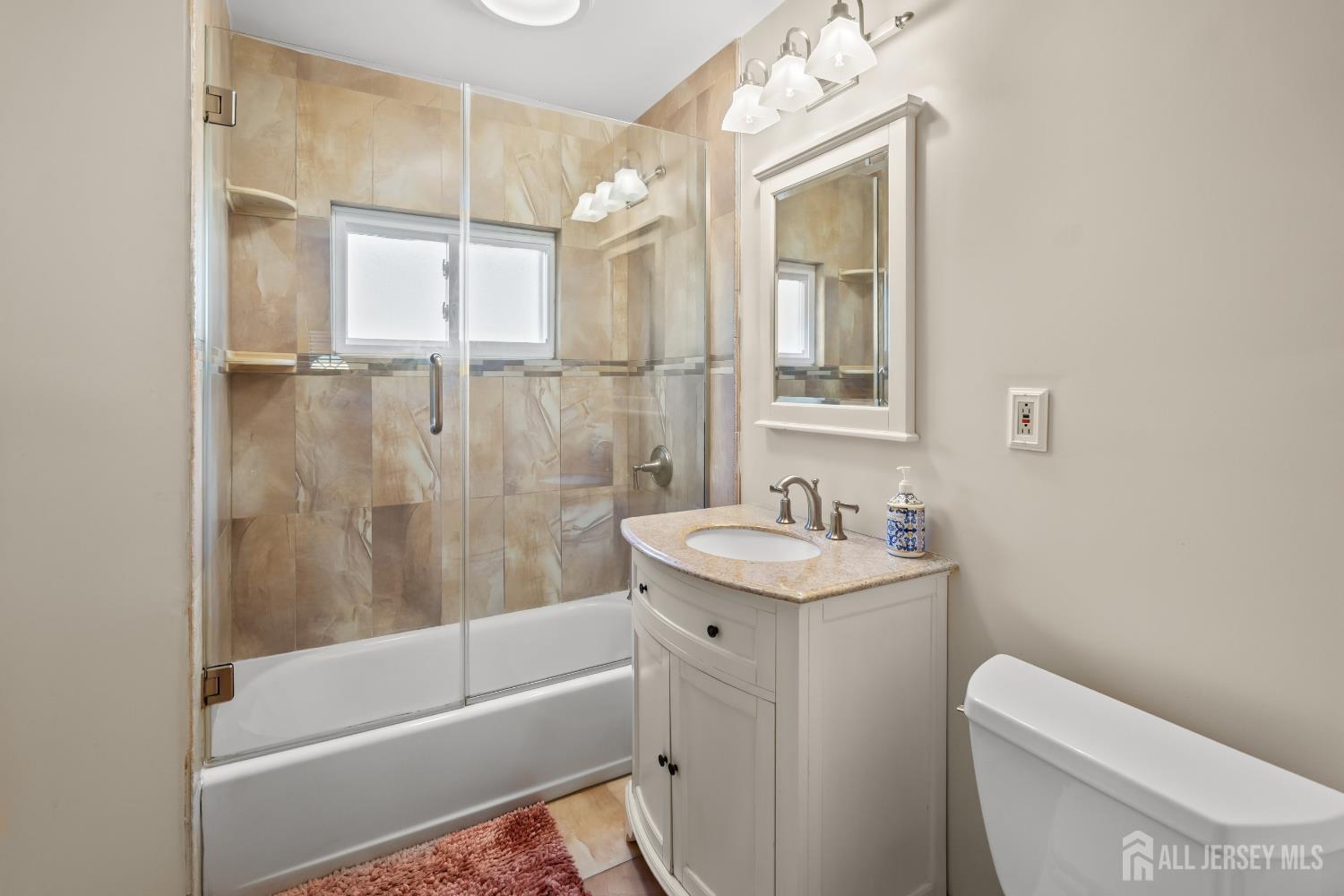 131 Woodland Road Piscataway, NJ 08854 - Photo 26 of 40 a bathroom with a granite countertop sink a toilet and shower