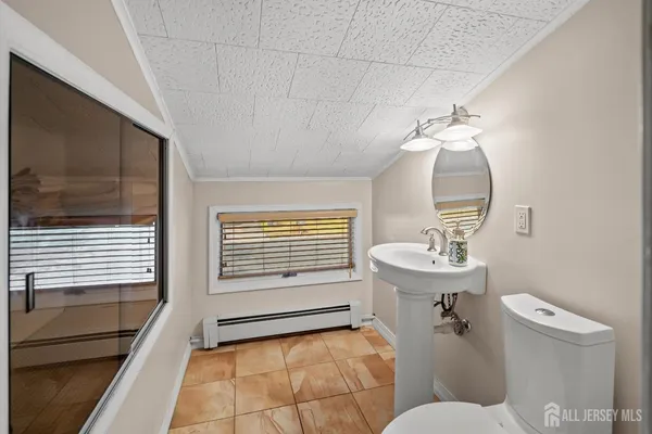 a bathroom with a sink a toilet and mirror