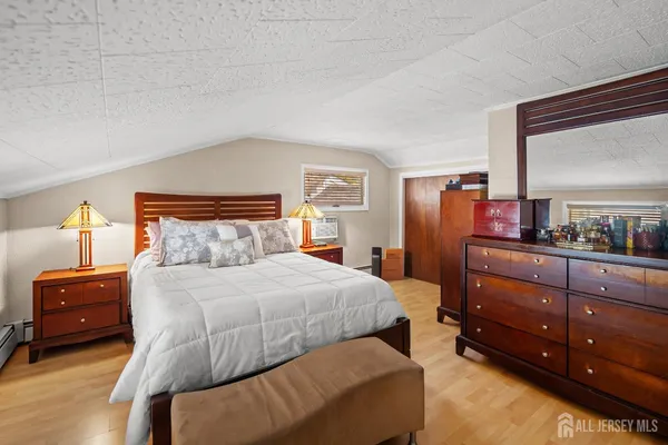 a bedroom with a bed and a dresser