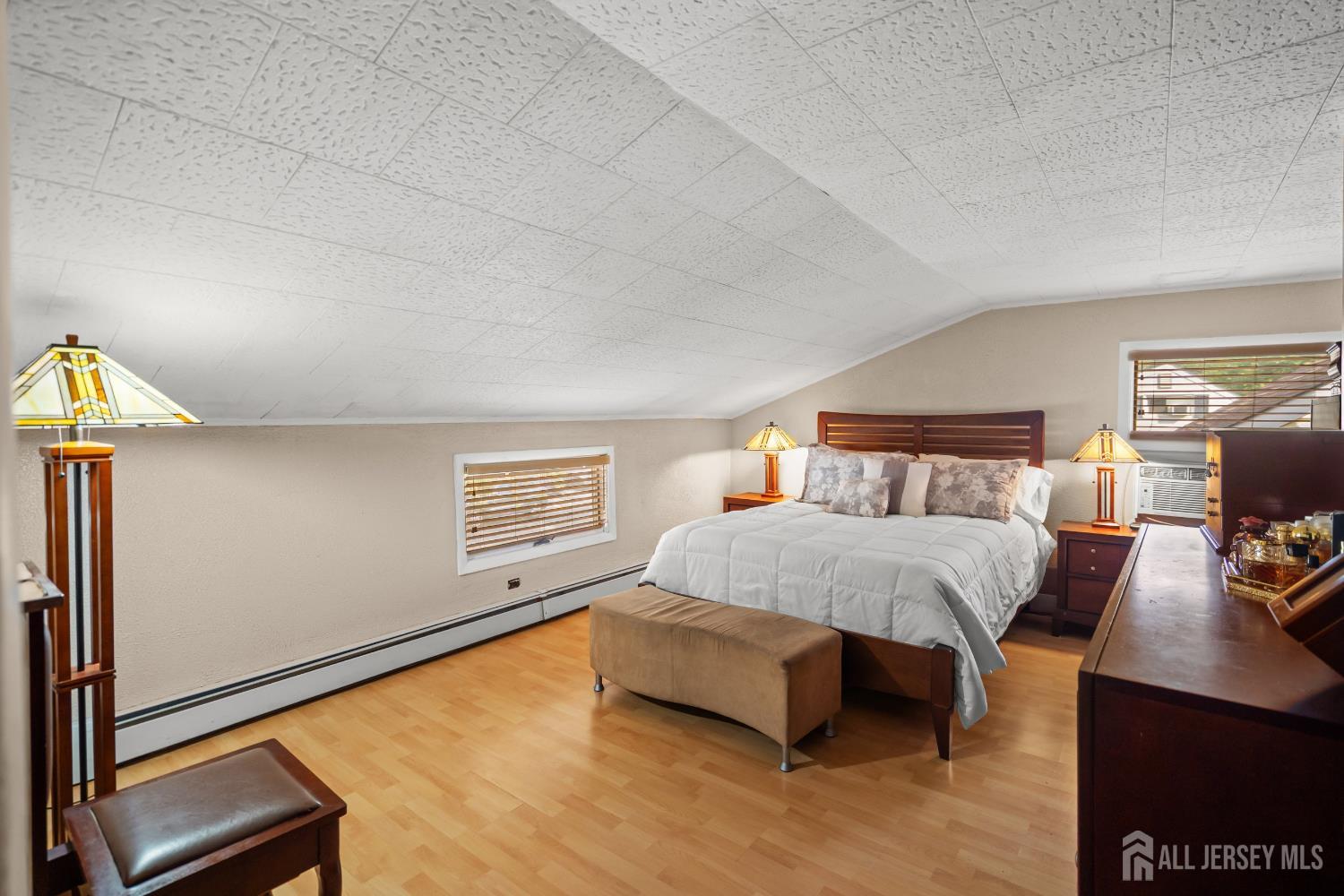 131 Woodland Road Piscataway, NJ 08854 - Photo 32 of 40 a bedroom with a bed and wooden floor