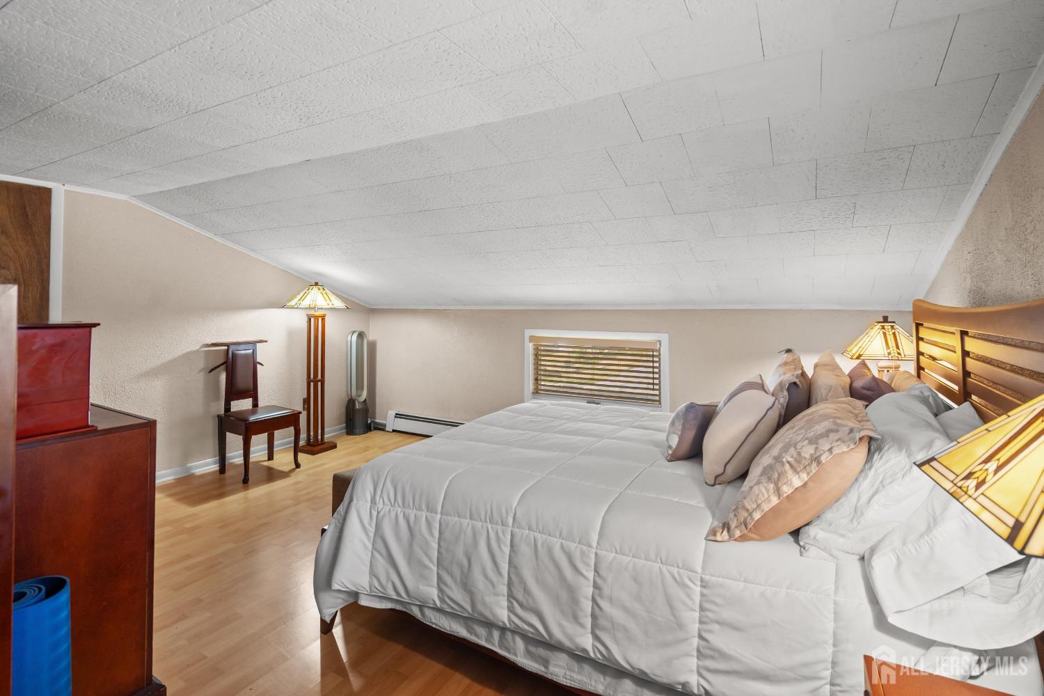 131 Woodland Road Piscataway, NJ 08854 - Photo 33 of 40 a bedroom with a bed and a chandelier