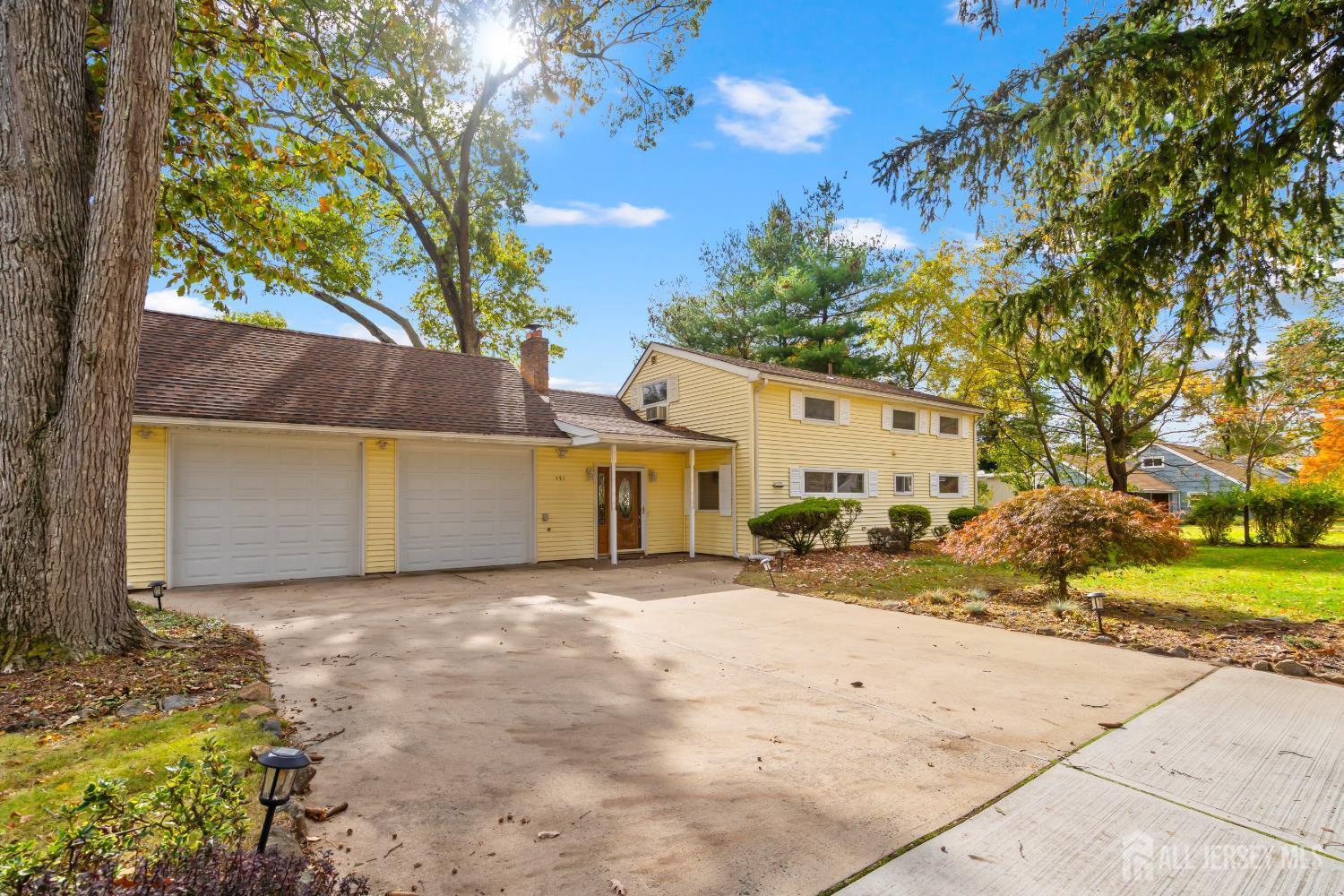 131 Woodland Road Piscataway, NJ 08854 - Photo 8 of 40 a view of a house with a yard and garage