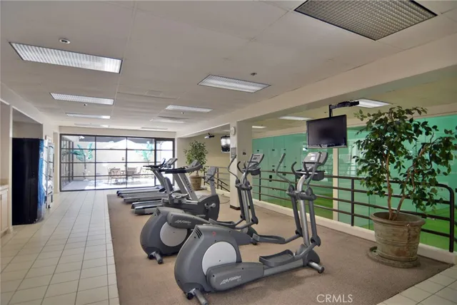 a room with gym equipment and large mirror