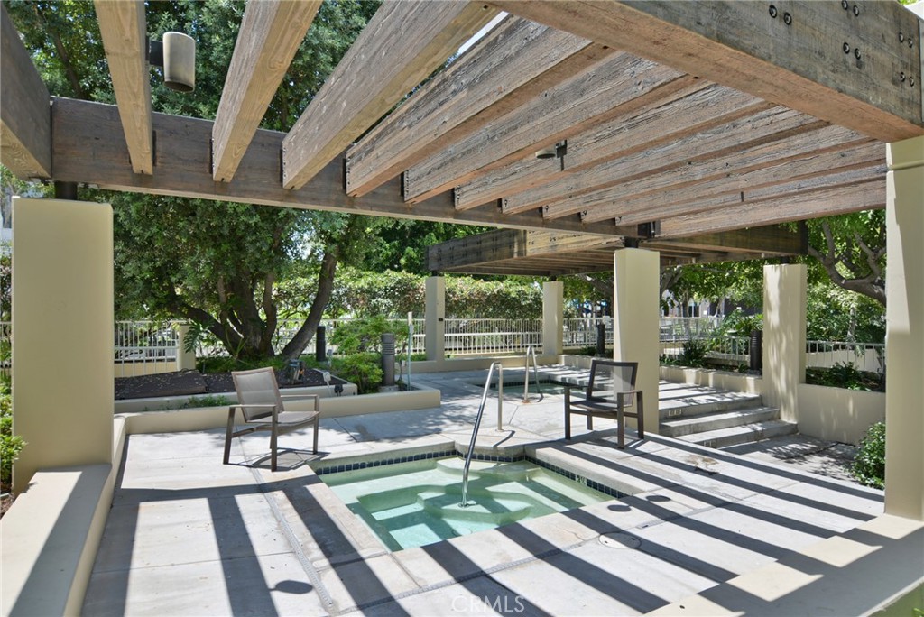 600 West 9th Street, Unit 1114 Los Angeles, CA 90015 - Photo 26 of 27 a view of a patio with table and chairs floor to ceiling window with wooden floor