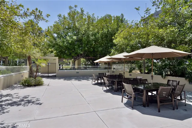a patio with tables and chairs