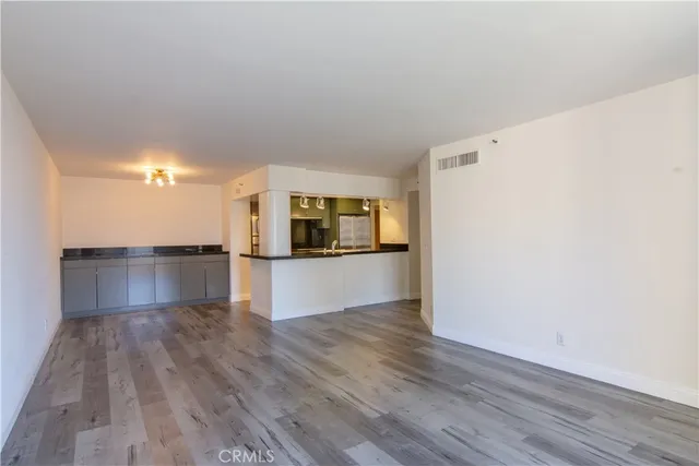 a kitchen with a refrigerator and a stove top oven