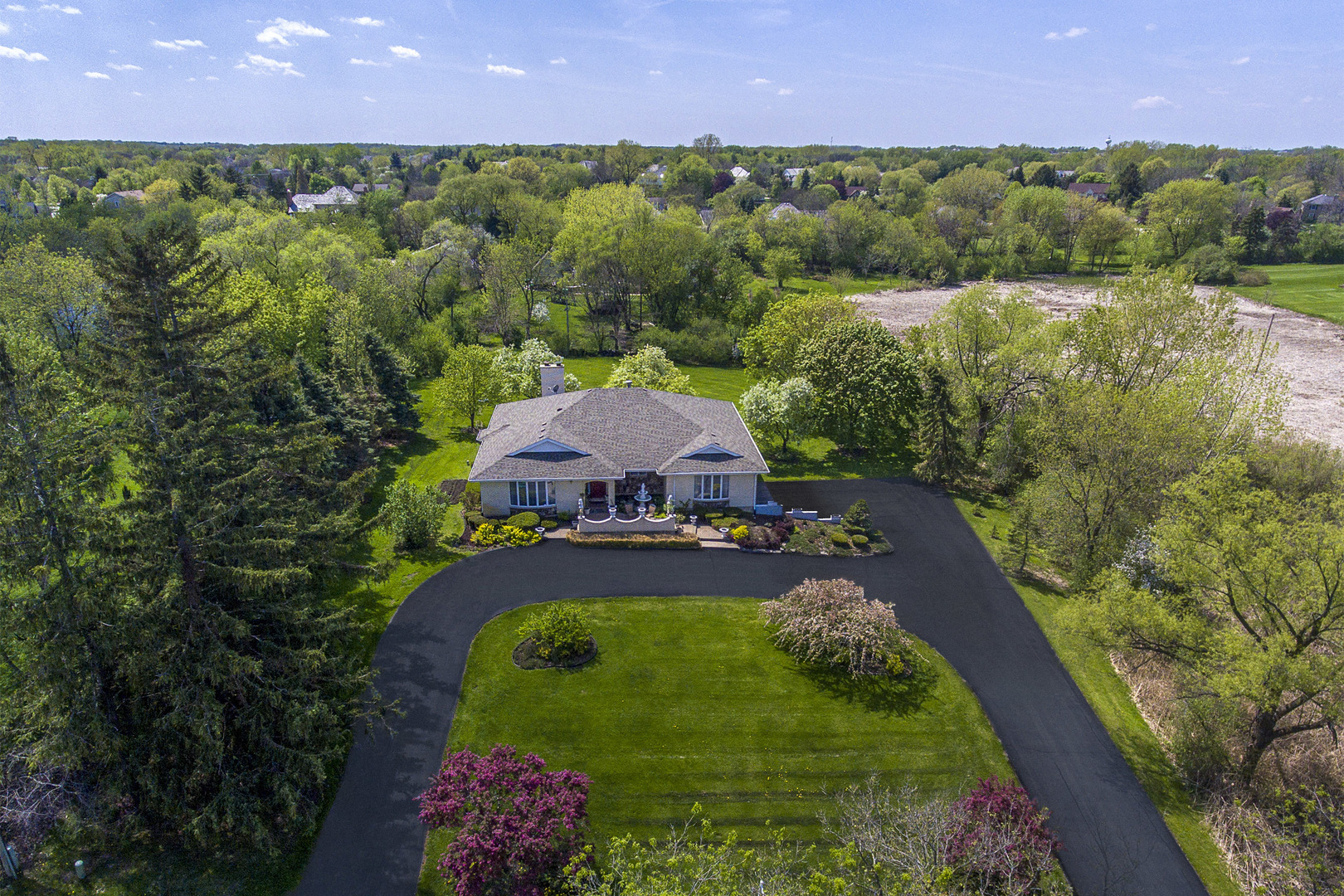 an aerial view of a house with a garden and yard