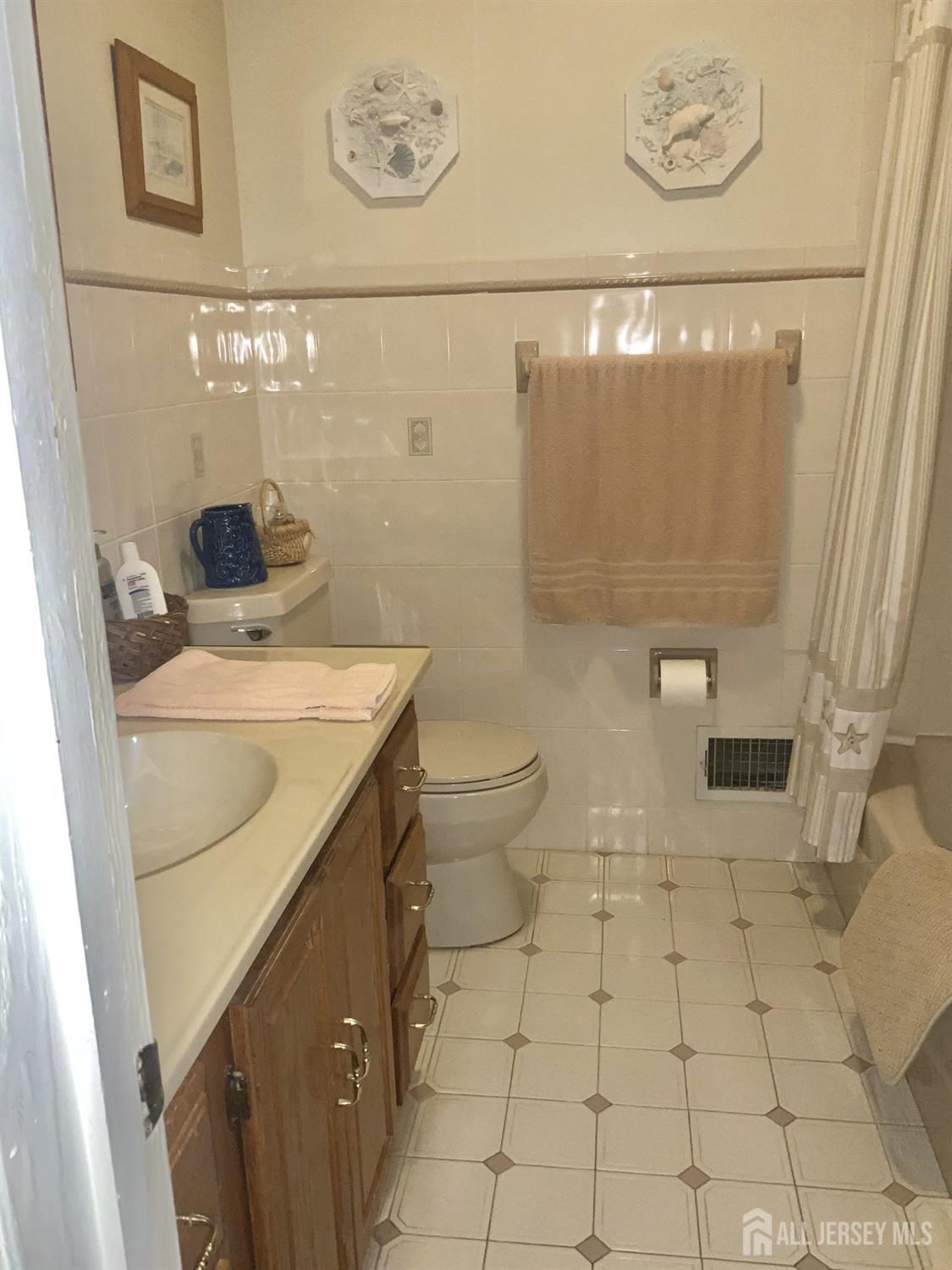 178 Willow Street Port Reading, NJ 07064 - Photo 12 of 15 a bathroom with a sink a toilet and shower