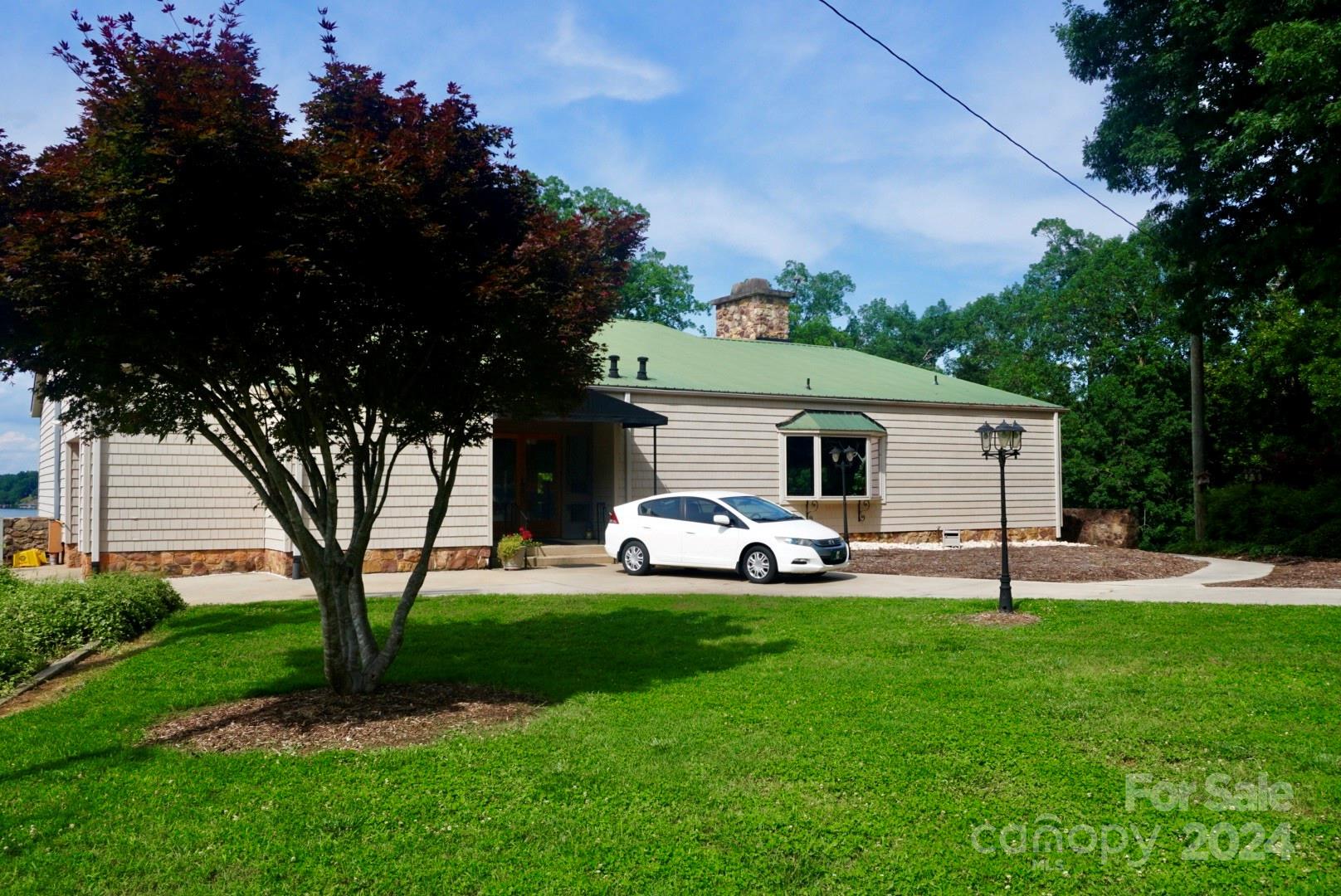 1025 Fairfield Road Mount Gilead, NC 27306 - Photo 4 of 12 a view of a house with backyard and a tree