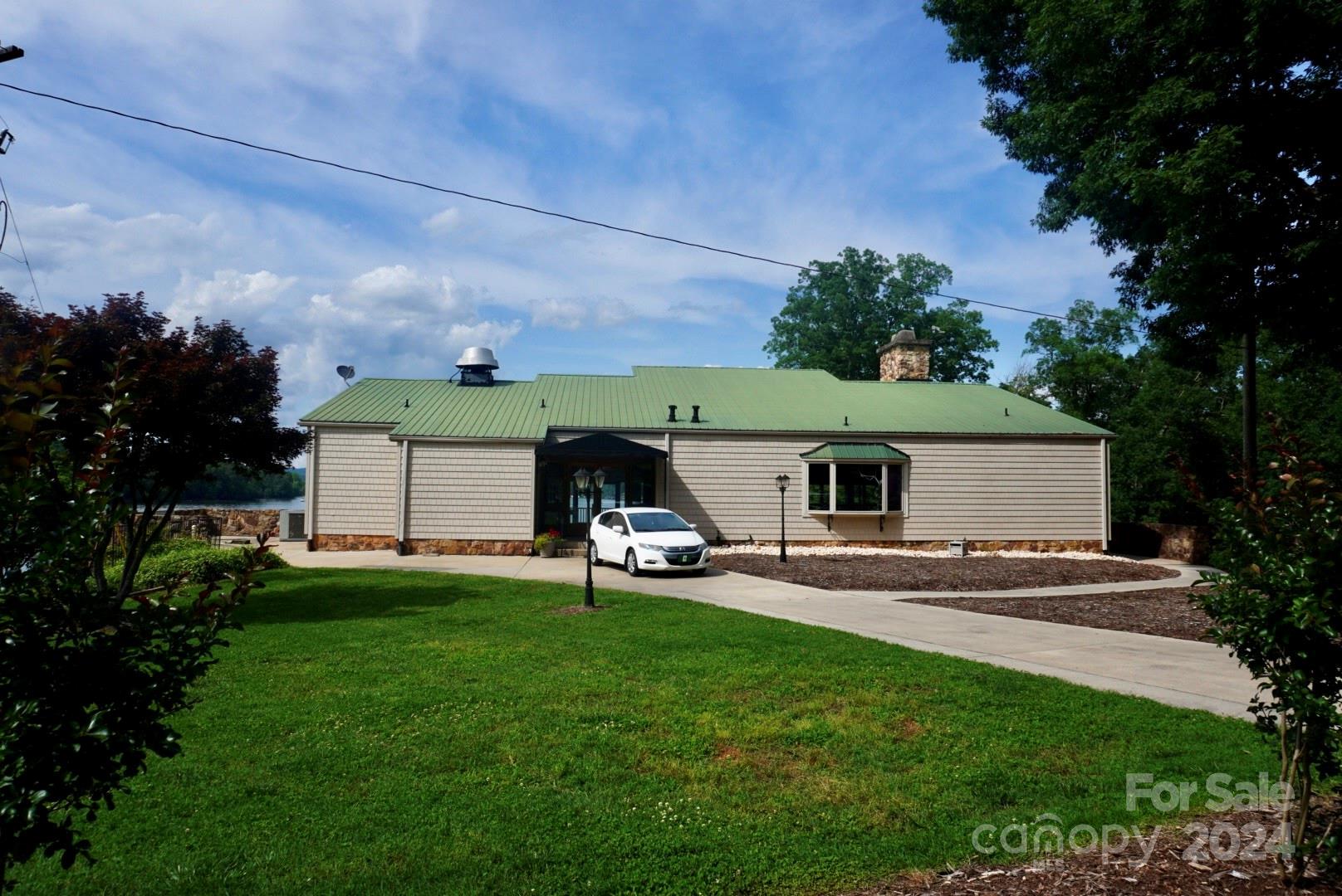 1025 Fairfield Road Mount Gilead, NC 27306 - Photo 5 of 12 a view of a backyard with sitting area and garden