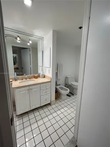 a bathroom with a sink a toilet and mirror