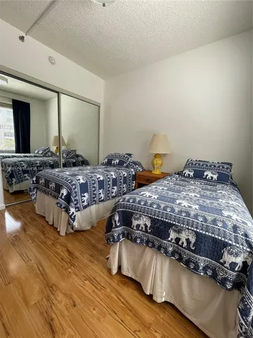 a bedroom with two beds and painting on the wall