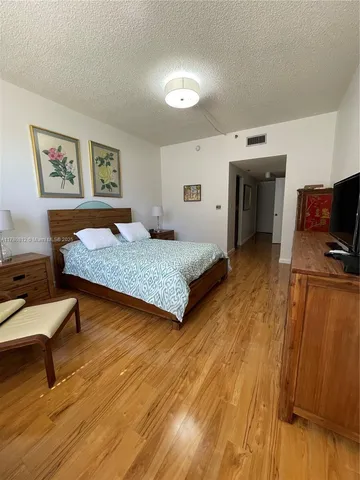 a bedroom with a bed and a television