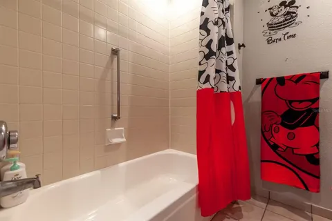 a bathroom with a bathtub and shower
