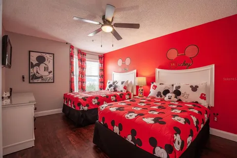 a bedroom with a bed and a chandelier