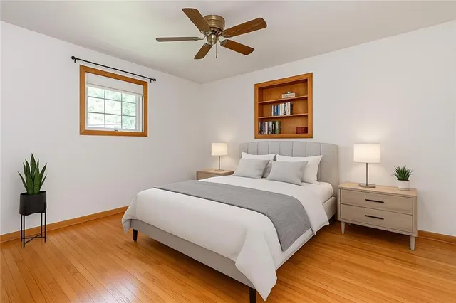 a bedroom with a bed and a window