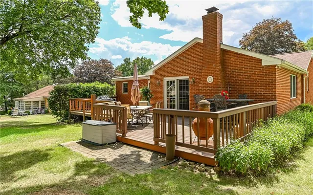 a roof deck with table and chairs potted plants with wooden fence