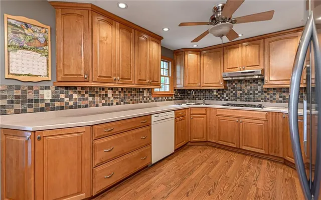 a kitchen with a sink window and cabinets