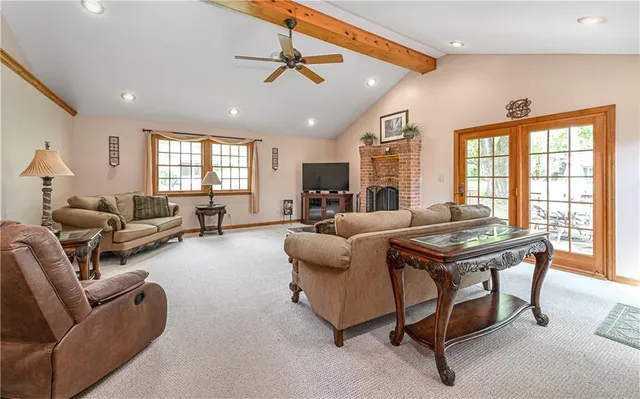 a living room with furniture a ceiling fan and a window
