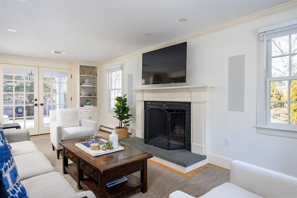 7 Village Lane Hingham, MA 02043 - Photo 11 of 34 a living room with furniture a flat screen tv and a fireplace