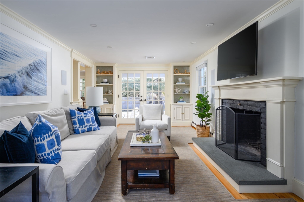 7 Village Lane Hingham, MA 02043 - Photo 12 of 34 a living room with furniture a flat screen tv and a fireplace