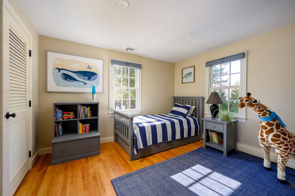 7 Village Lane Hingham, MA 02043 - Photo 22 of 34 a spacious bedroom with a bed and wooden floor