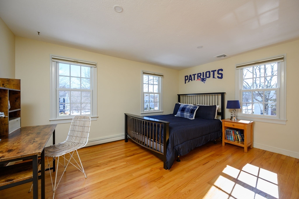 7 Village Lane Hingham, MA 02043 - Photo 23 of 34 a living room with a bed furniture and a window