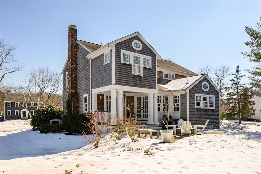 7 Village Lane Hingham, MA 02043 - Photo 32 of 34 a front view of a house with a yard covered in snow