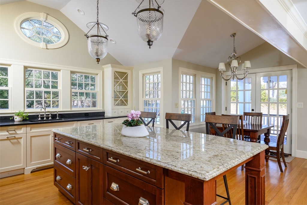 7 Village Lane Hingham, MA 02043 - Photo 4 of 34 a dining hall with stainless steel appliances granite countertop a kitchen island a stove and a wooden cabinets