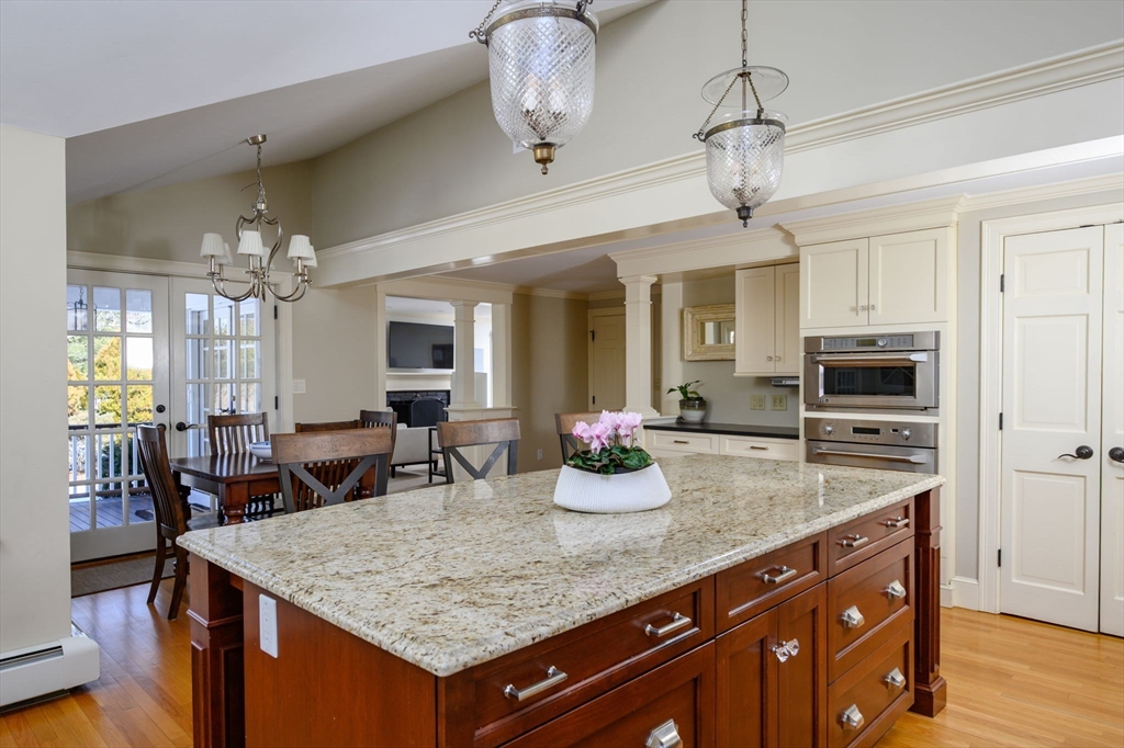 7 Village Lane Hingham, MA 02043 - Photo 5 of 34 a kitchen with a counter space center island and stainless steel appliances